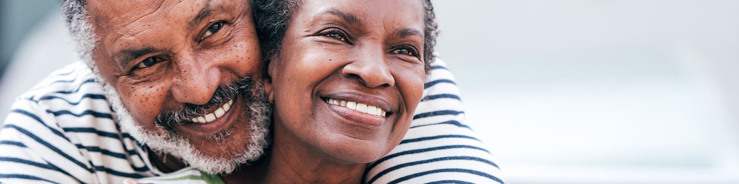 Smiling older couple enjoying a confident smile with dentures in El Paso